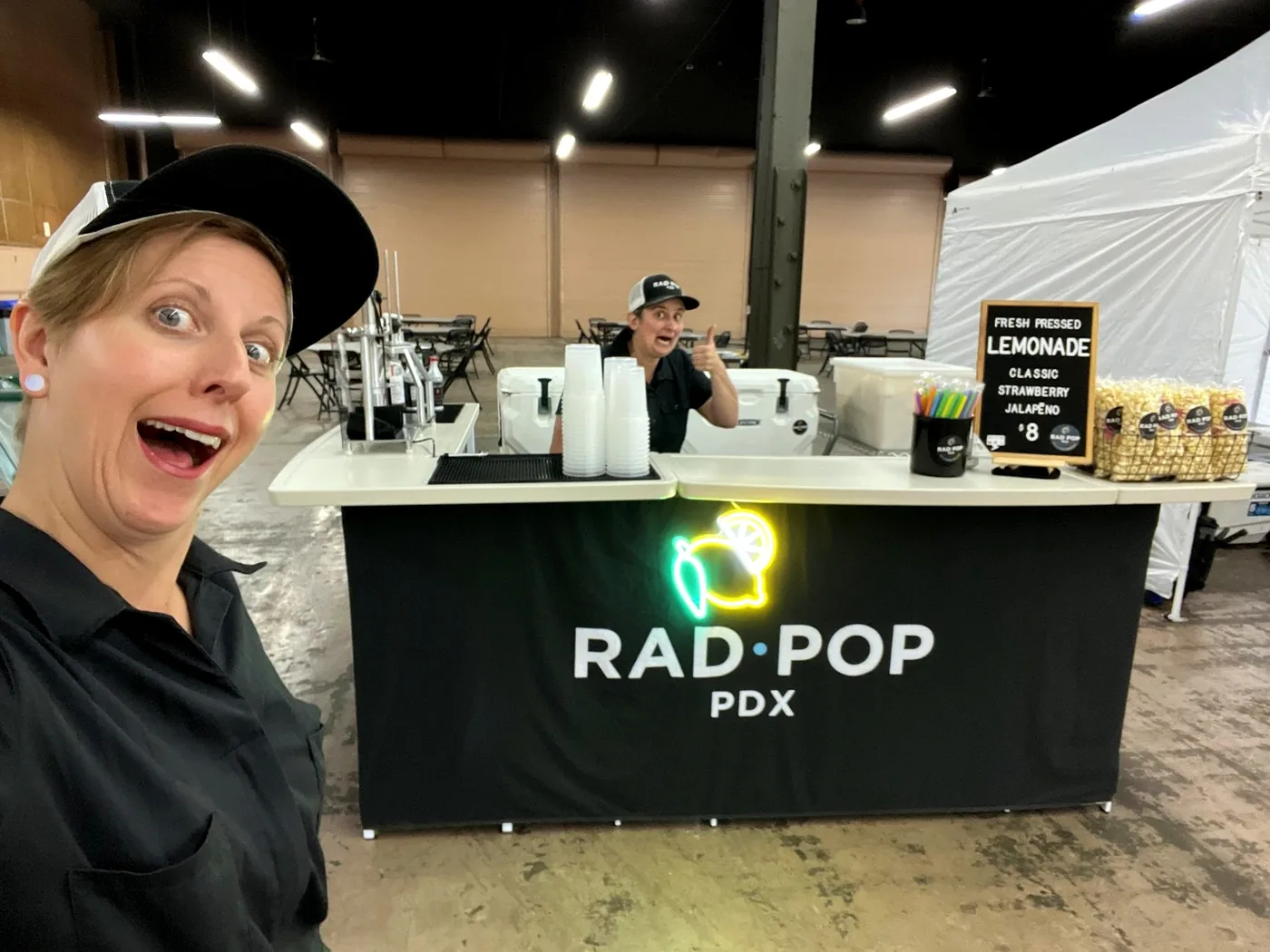 Rad Pop lemonade and popcorn booth set up inside a large event hall